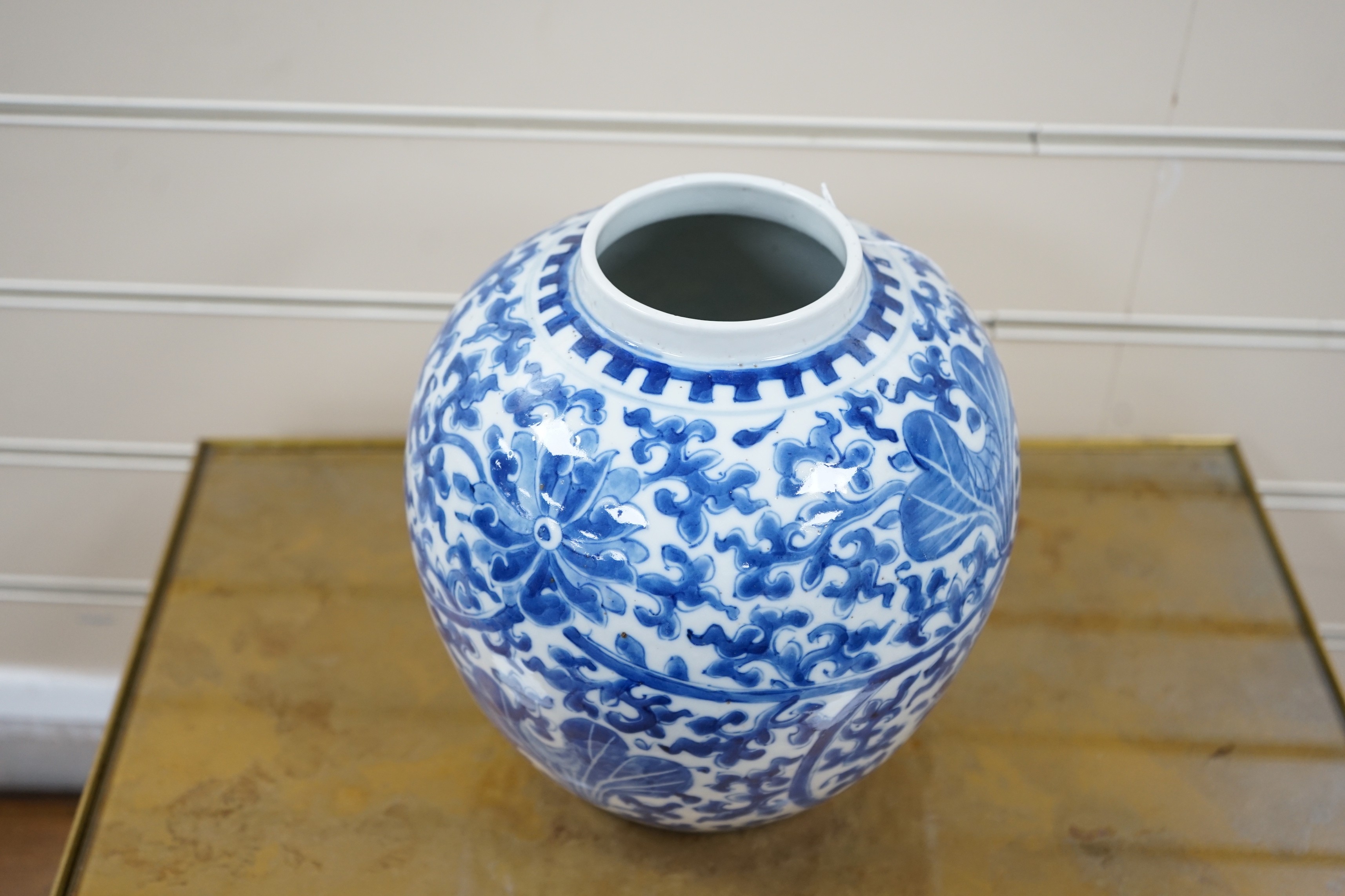 A late 19th century Chinese blue and white ovoid jar. 22cm tall, apocryphal Kangxi mark